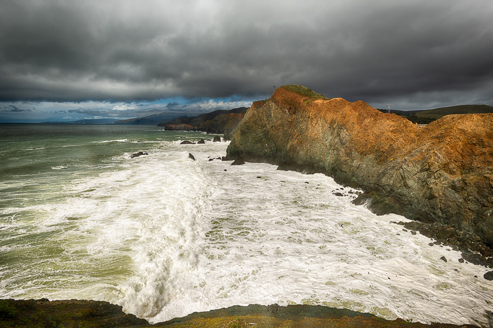 view north from Point Bonita lighthouse with big waves and dark clouds